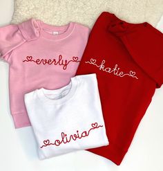 three sweaters with the word love written on them are laying next to each other