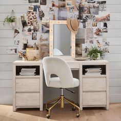 a desk with a chair, mirror and pictures on the wall in front of it