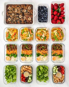 six containers filled with different types of salads and fruit on top of a white table