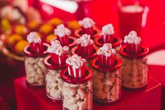 red containers filled with popcorn sitting on top of a table