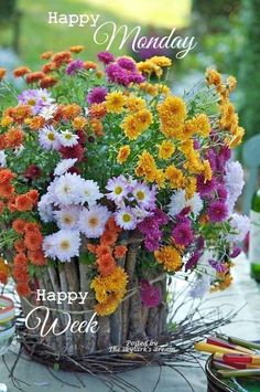 a basket filled with lots of flowers on top of a table