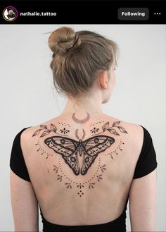 a woman with a butterfly tattoo on her back