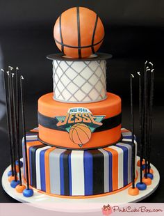 a three tiered cake with basketballs on top