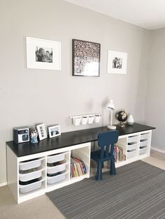 a room with a desk, bookshelf and pictures on the wall