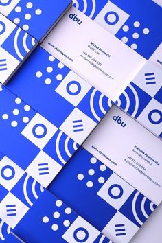 blue and white business cards stacked on top of each other with circles, dots and squares