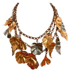 Rare and unique Gerda Lynggaard leaves necklace. What a statement jewelry. Necklace has three strands of chain and layer with bronze and silver leaf pendant. see measurement on picture attached. Leather Leaf Necklace, Autumn Shopping, Statement Jewelry Necklace, Leaves Necklace, Autumn Chic, Three Strand Necklace, Ren Fest, Colors Of Autumn, Jewellery Sketches