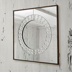 a mirror hanging on the side of a wall