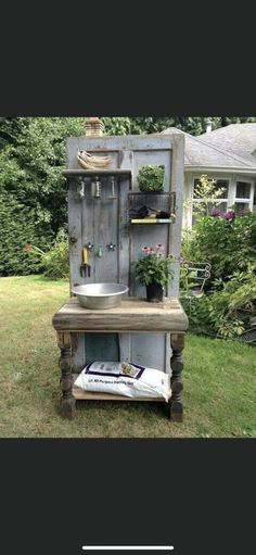 an old cabinet is turned into a potting planter and sink in the yard