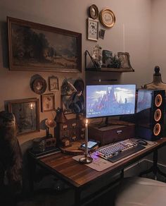 a desk with a computer, keyboard and mouse on it in front of some pictures