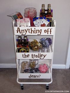 a white cart filled with lots of different types of drinks and confection items