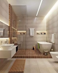 a bathroom with two sinks, a bathtub and a toilet