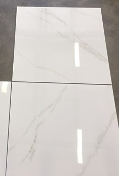 the white marble is laid out on the floor and ready to be used as a table top