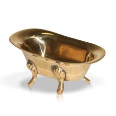 a gold bathtub with legs and feet on the side, sitting in front of a white background