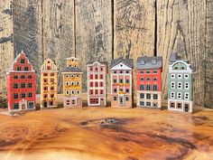 a group of small buildings sitting on top of a wooden table next to each other