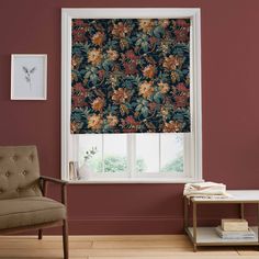 a living room with a chair and window covered in floral print roman blind coverings