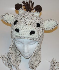 a crocheted cow hat with horns on it