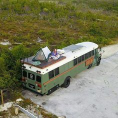 an old bus is parked on the side of the road with its roof open and it's sunroofing