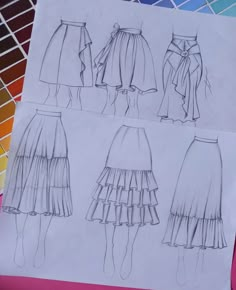 four different skirts are shown on top of a piece of paper