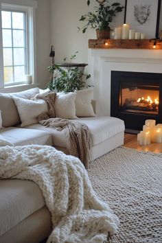 a living room filled with furniture and a fire place next to a fireplace covered in candles