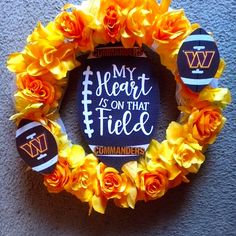 a wreath made out of flowers with the words my heart is on that field