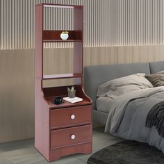 a bedroom with a bed, dresser and mirror on it's side table in front of the bed