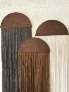 three brown and white wall hangings with fringe