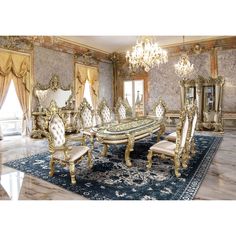 an ornate dining room with gold furniture and chandelier hanging from the ceiling over a blue area rug