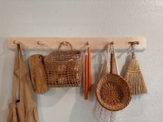 some baskets and brooms hanging on a wall