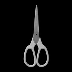 a pair of white scissors on a black background