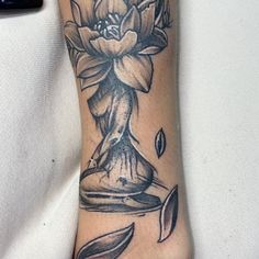 a woman's foot with a flower tattoo on it