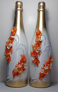 two white vases with orange flowers painted on them