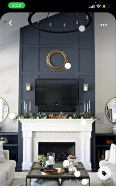 a living room with a fireplace, couches and a large mirror on the wall