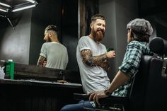 Cheerful friendly barber with long beard smiling and holding a glass while talking to his client Long Beard, Long Beards, Business Icons, Business Icons Design, Icons Design, Man Photo, Art Club, Barber Shop, Photo Magazine