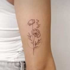 a woman's arm with a flower tattoo on the left side of her body