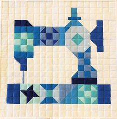 a blue and white quilted piece with an image of a sewing machine on it