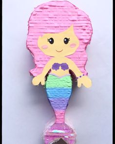 a little mermaid doll with pink hair and blue eyes