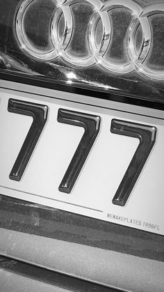 the front grill of an old car with numbers seven and seven in black and white