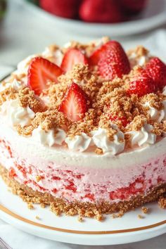 there is a cake with strawberries on the top and crumbs all over it