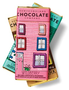 chocolate bars stacked on top of each other in front of a building with windows and shutters