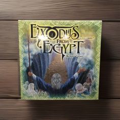 the front cover of an exodis from egypt board game on a wooden surface