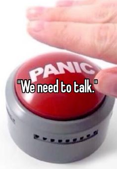 someone holding their hand up to a red button that says panic we need to talk