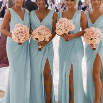 the bridesmaids are all dressed in blue dresses and holding their bouquets together