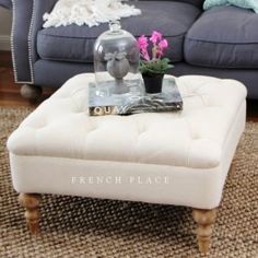 a living room with a blue couch and coffee table in front of a gray sofa