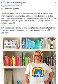 a woman standing in front of a bookshelf with a rainbow t - shirt on