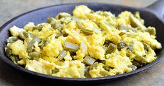 scrambled eggs in a skillet on a table