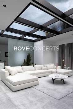 a living room filled with white furniture under a skylight