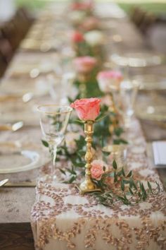 a long table with candles and flowers on it