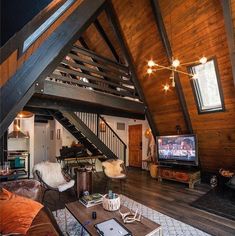 a living room filled with furniture and a flat screen tv on top of a wooden floor