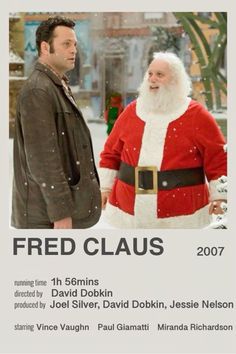 a man in a santa suit standing next to a poster for the movie fried claus