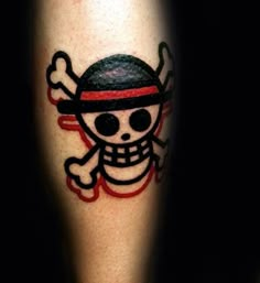 a skull and crossbones tattoo is on the leg of a person's leg